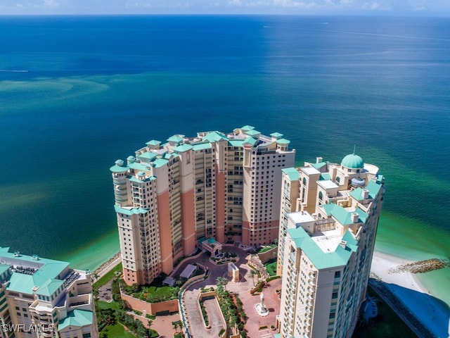 bird's eye view featuring a water view and a beach view