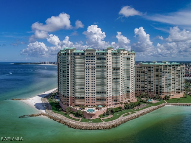 exterior space featuring a beach view and a water view