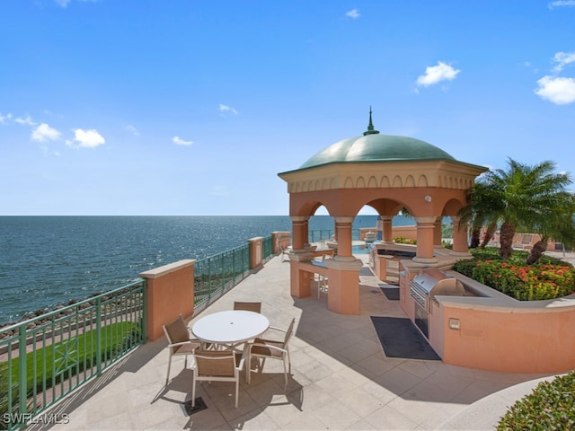 view of patio featuring area for grilling, a gazebo, and a water view