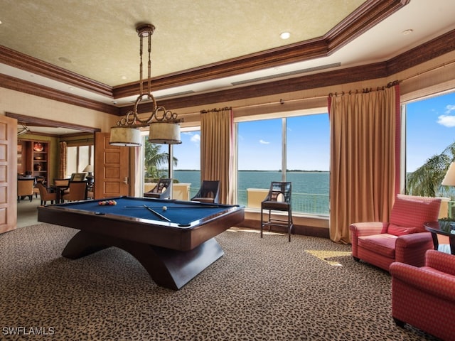 recreation room with a water view, carpet flooring, crown molding, and a raised ceiling