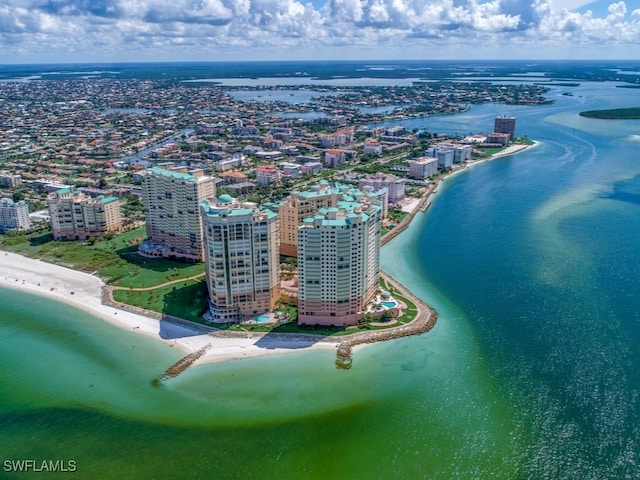 bird's eye view with a water view and a beach view