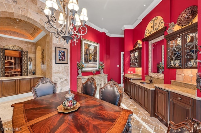 dining room with ornamental molding, sink, and a chandelier