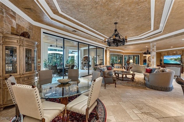 dining room featuring ornamental molding, a tray ceiling, and a chandelier