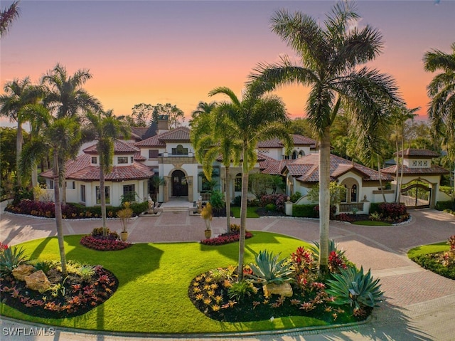 mediterranean / spanish-style house with a lawn