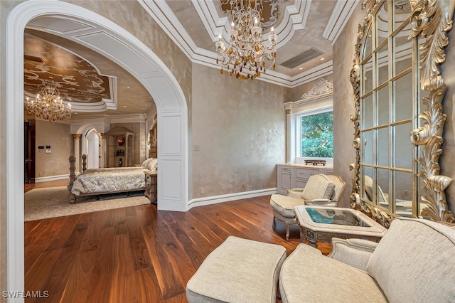 living area featuring a raised ceiling, crown molding, and dark hardwood / wood-style floors