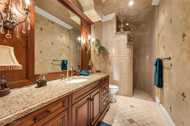 bathroom featuring tile patterned floors, crown molding, tiled shower, vanity, and toilet