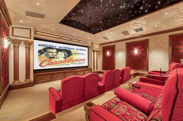 home theater room with ornamental molding, carpet floors, and ornate columns