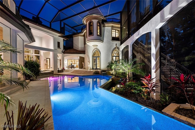 view of swimming pool with a patio and a lanai