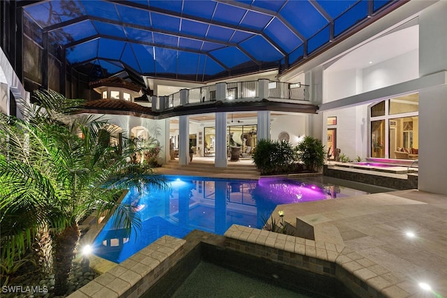 view of swimming pool featuring a lanai, an in ground hot tub, and a patio area