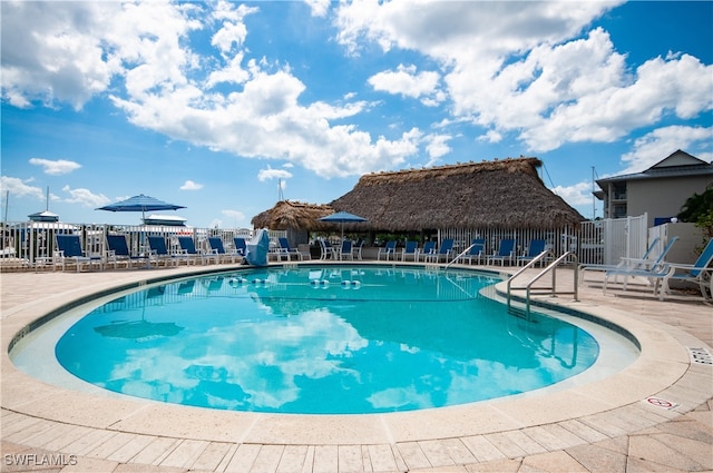 community pool featuring a patio area and fence