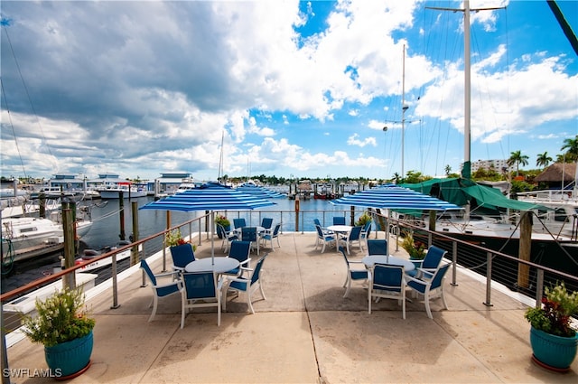 view of patio / terrace featuring a water view and outdoor dining space