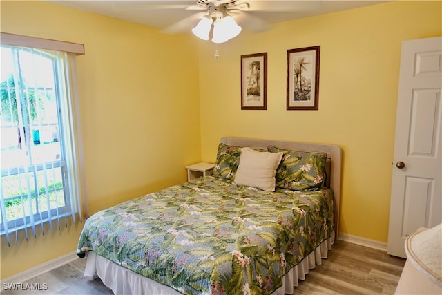 bedroom with ceiling fan and hardwood / wood-style flooring