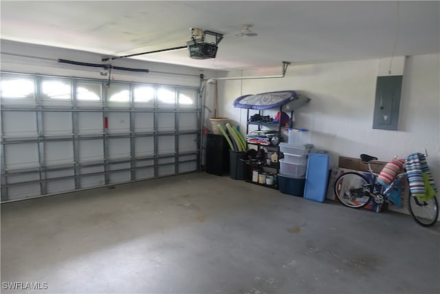 garage with electric panel and a garage door opener