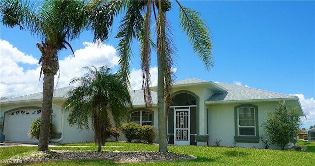 ranch-style house featuring a front lawn and a garage