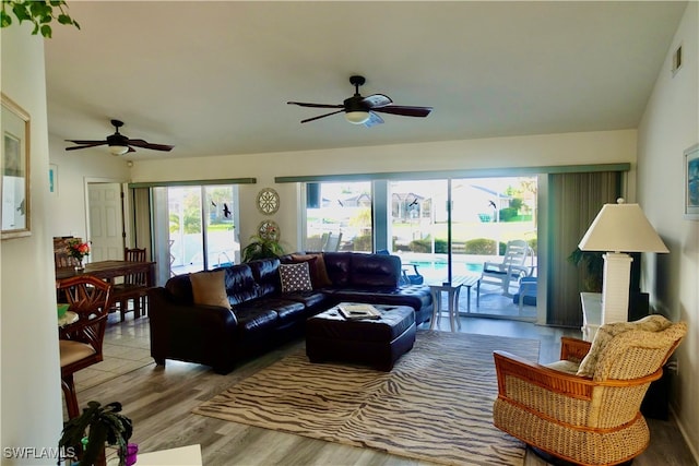 living room with ceiling fan and light wood-type flooring