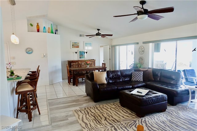 living room featuring light hardwood / wood-style floors and ceiling fan