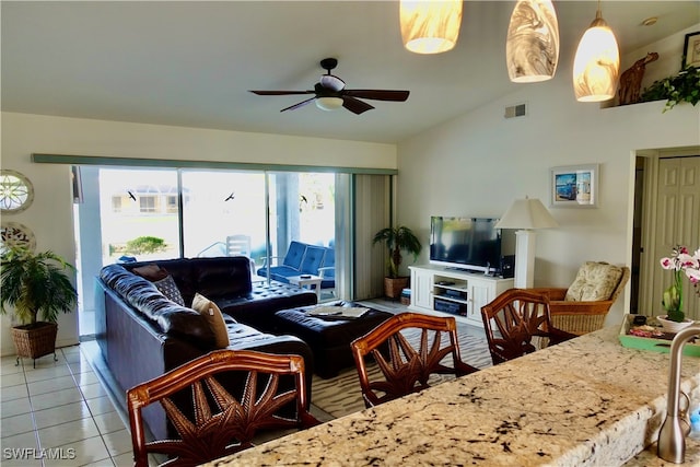 tiled living room with ceiling fan and lofted ceiling