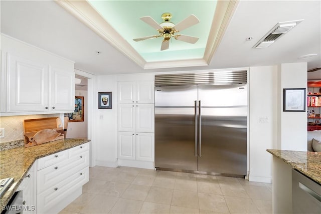 kitchen with light stone countertops, stainless steel appliances, a ceiling fan, visible vents, and white cabinetry