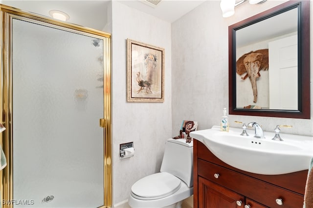 bathroom with toilet, a shower with shower door, and vanity