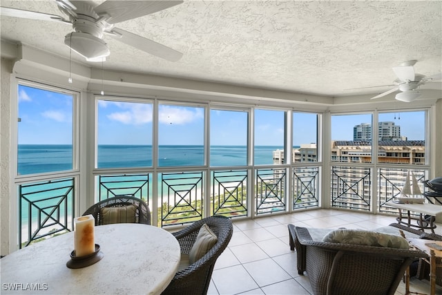 sunroom / solarium featuring a water view and a wealth of natural light