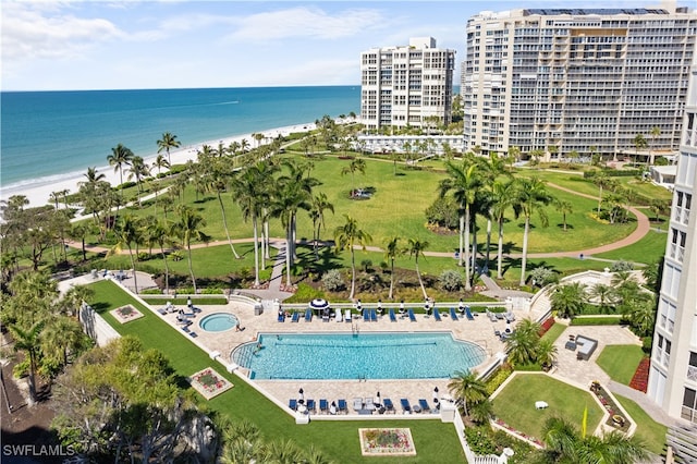 bird's eye view featuring a water view and a beach view