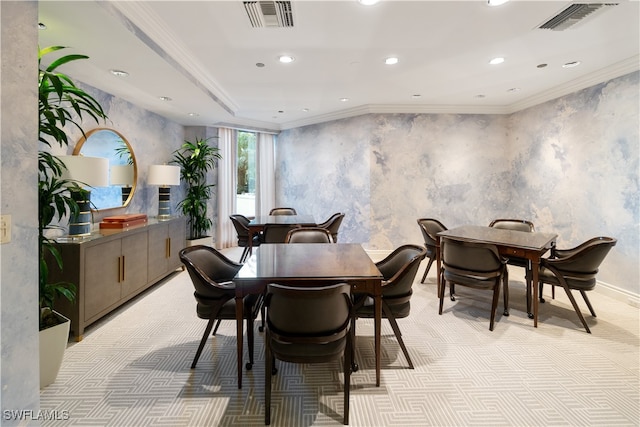 carpeted dining space featuring crown molding