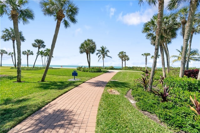 view of property's community with a water view and a yard