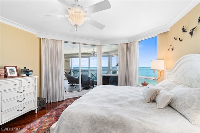 bedroom with crown molding, dark wood-type flooring, a water view, and ceiling fan