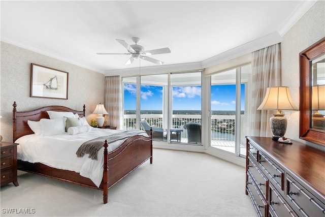 carpeted bedroom featuring ornamental molding, access to exterior, a water view, and ceiling fan