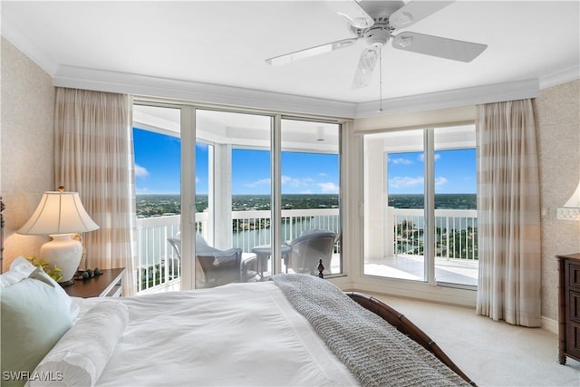 carpeted bedroom featuring a water view, crown molding, and access to outside