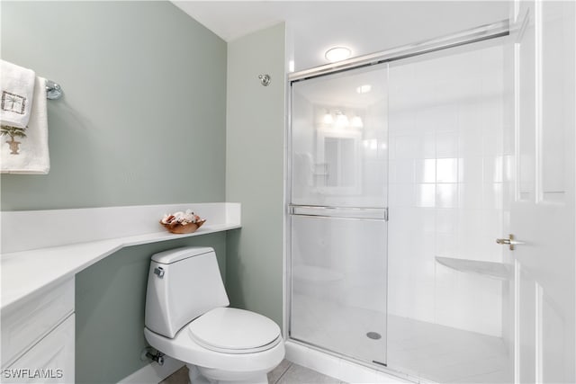 bathroom featuring vanity, toilet, tile patterned flooring, and an enclosed shower