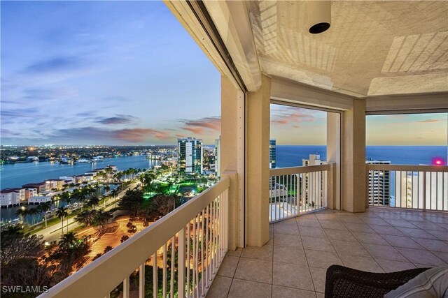 balcony with a view of city and a water view