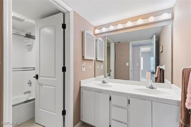 bathroom with shower / bath combination with glass door, vanity, and tile patterned floors