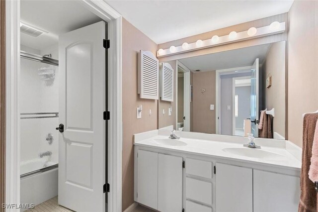 1036 S Collier Blvd Unit 101, Marco Island, FL 34145 - bathroom with double vanity and shower / bath combination with glass door