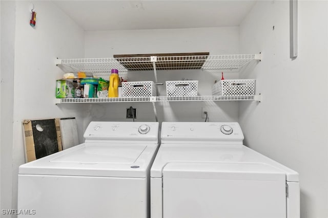 laundry room featuring washing machine and clothes dryer