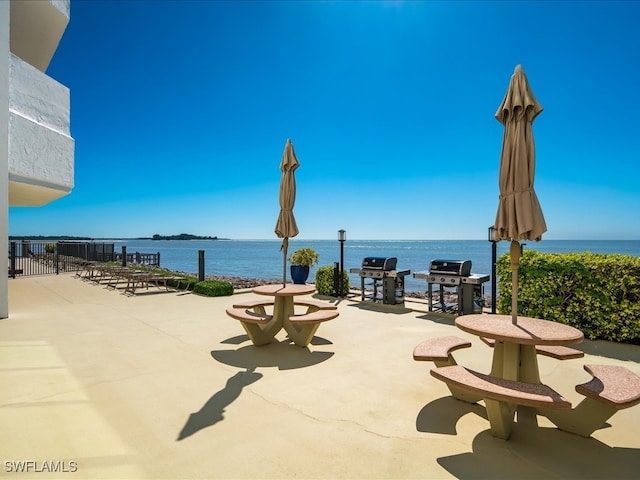 view of patio featuring grilling area and a water view