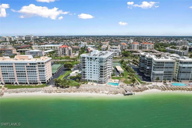 drone / aerial view with a water view and a beach view