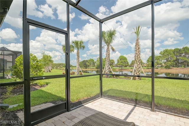 unfurnished sunroom with a water view