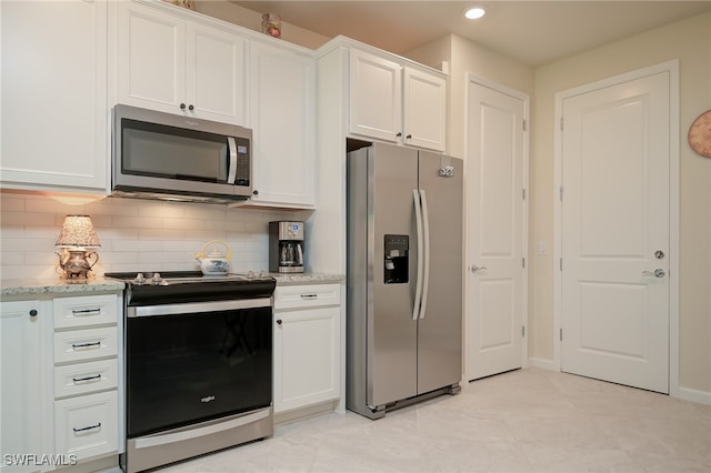 kitchen featuring decorative backsplash, stainless steel appliances, white cabinetry, and light stone counters