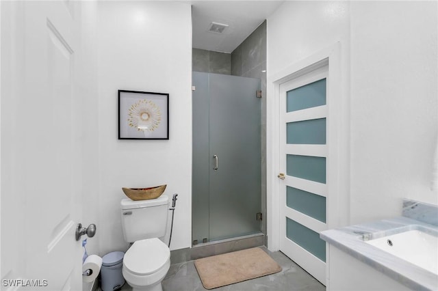 bathroom featuring toilet, concrete floors, a shower with door, and vanity