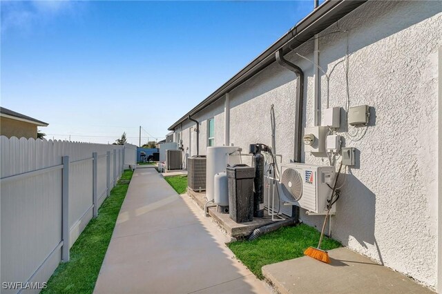 view of side of property featuring central AC unit, a patio, and ac unit