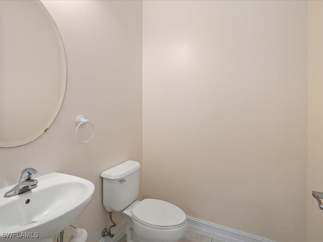 9098 Capistrano St S Unit 7103, Naples, FL 34113 - bathroom featuring a sink, toilet, baseboards, and tile patterned floors