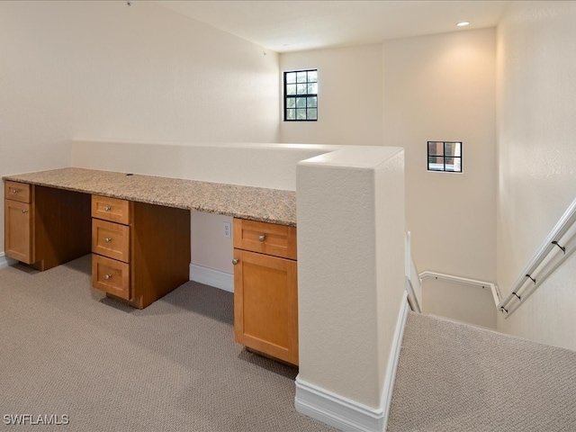 unfurnished office featuring light carpet and built in desk