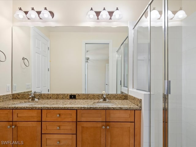 bathroom featuring vanity and a shower with door