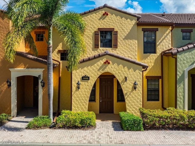 9098 Capistrano St S Unit 7103, Naples, FL 34113 - mediterranean / spanish-style house featuring a tile roof and stucco siding