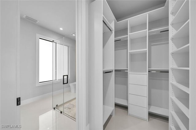 spacious closet featuring visible vents