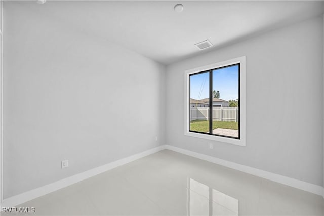 empty room with visible vents and baseboards