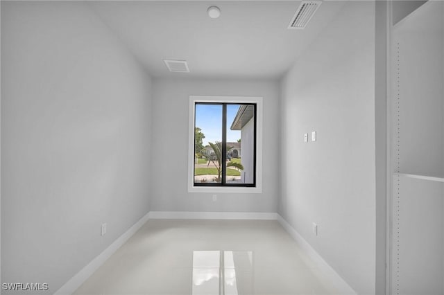 unfurnished room with visible vents and baseboards