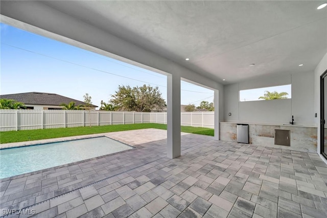 view of patio / terrace featuring a fenced backyard and a fenced in pool