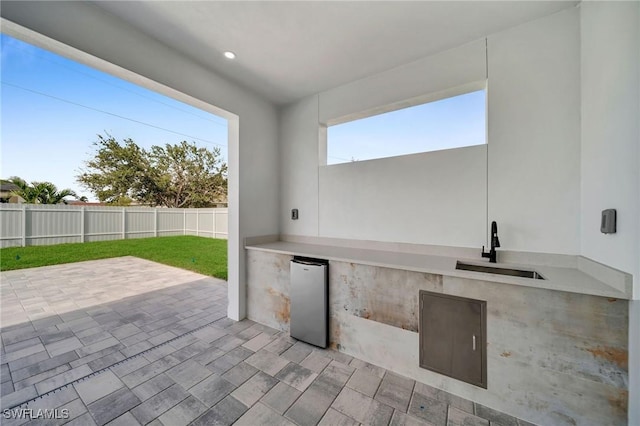 view of patio with an outdoor kitchen and sink